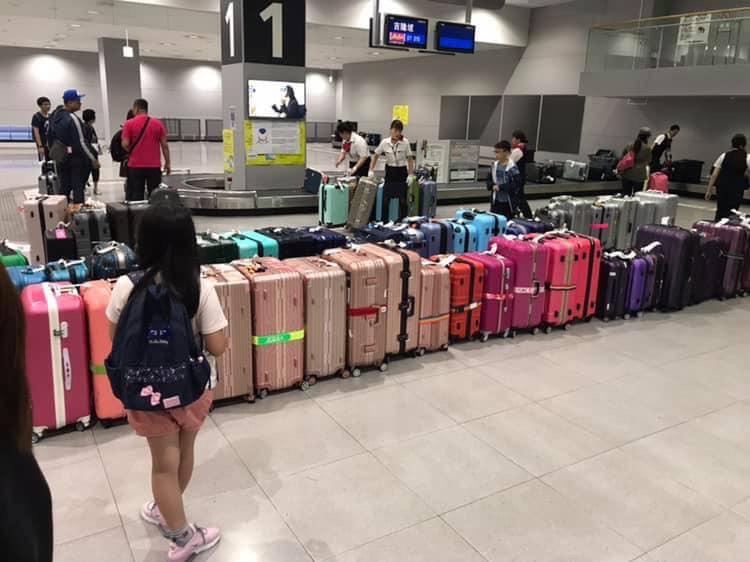 At the Japanese airport, baggage is being sorted by colors to make it easier for passengers to find their